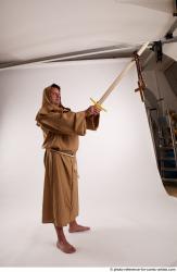 JOEL_ADAMSON STANDING POSE WITH SWORD AND CRUCIFIX